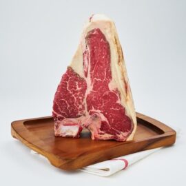 A thick, beautifully marbled 45 Days Dry Aged Barley Fed Porterhouse Steak MS3+ ready for cooking.