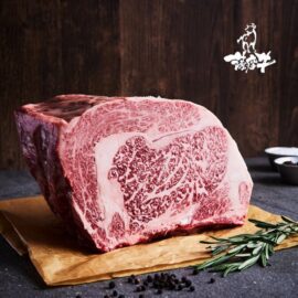 A beautifully marbled, uncooked A5 Satsuma Wagyu Ribeye steak, flash-frozen and ready for preparation.