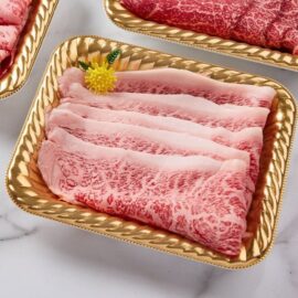 Paper-thin slices of A5 Satsuma Wagyu Rump Cap Shabu beautifully arranged, showcasing their intricate, snowflake-like marbling.