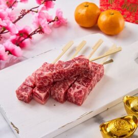 Close-up of perfectly marbled A5 Wagyu Beef Skewers, ready for grilling.