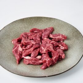 Close-up of premium halal grassfed beef stir fry strips, lean and perfectly sliced, ready for cooking.