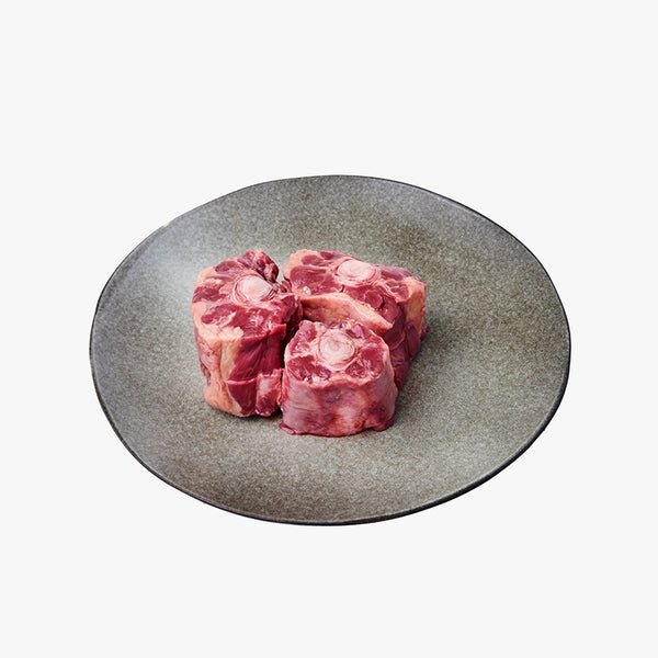 Close-up of rich, meaty Grassfed Free Range Oxtail pieces ready for cooking.