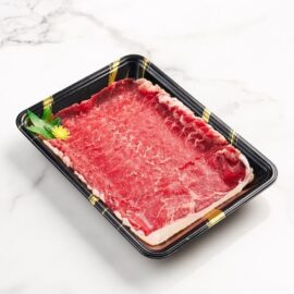 Wafer-thin slices of Barley Fed Striploin MS2-3 Shabu beef, arranged to display its fine marbling and vibrant red color.