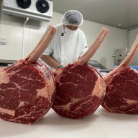 A perfectly frenched and trussed Bass Straits 100% Grassfed Lollipop Steak, showcasing its rich red color and fine marbling.