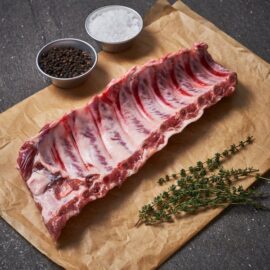 A full rack of premium Dingley Dell Pork Baby Back Ribs, showcasing excellent marbling and ready for cooking.