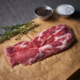 A fresh, beautifully marbled cut of Dingley Dell Pork Pluma ready for cooking.