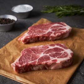 A perfectly marbled Dingley Dell Pork Ribeye Steak, ready for cooking.