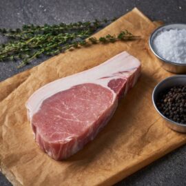 A close-up of a perfectly cooked Dingley Dell Pork Striploin Steak, sliced to show its juicy and tender interior.