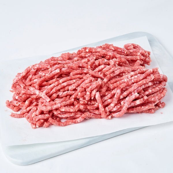 A close-up of coarse-ground Frozen Grassfed Beef Mince 80/20, showing its rich red color and texture.