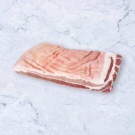 A large, high-quality slab of frozen pork belly roast, showing distinct layers of meat and fat.