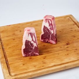 A close-up of thick, succulent, raw Lamb Loin Chops ready for cooking.