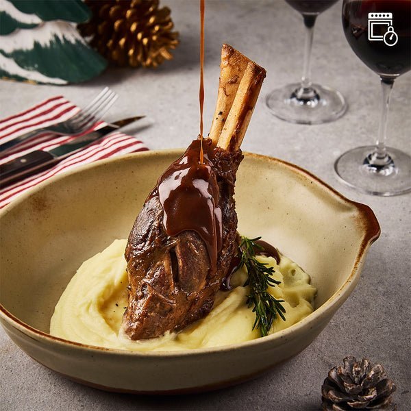 A perfectly cooked Lamb Shank with a rich Red Wine Jus sauce, ready to serve.