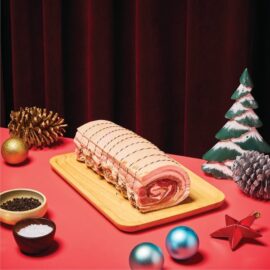 A beautifully roasted Meat Co. Traditional Porchetta with golden, crackling skin, ready to be sliced and served.