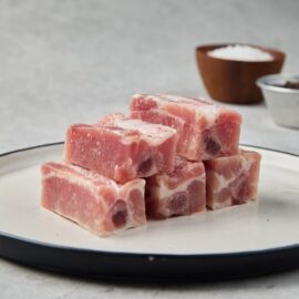 A fresh, meaty rack of pork spare ribs, ready for cooking.