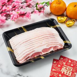 Finely sliced Olive Fed Duroc Pork Belly Shabu fanned out on a plate, showcasing its intricate marbling.