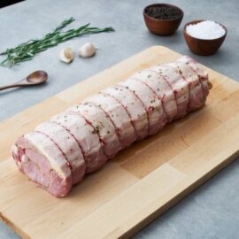 A beautifully rolled and seasoned rare breed pork loin roast, ready for the oven.