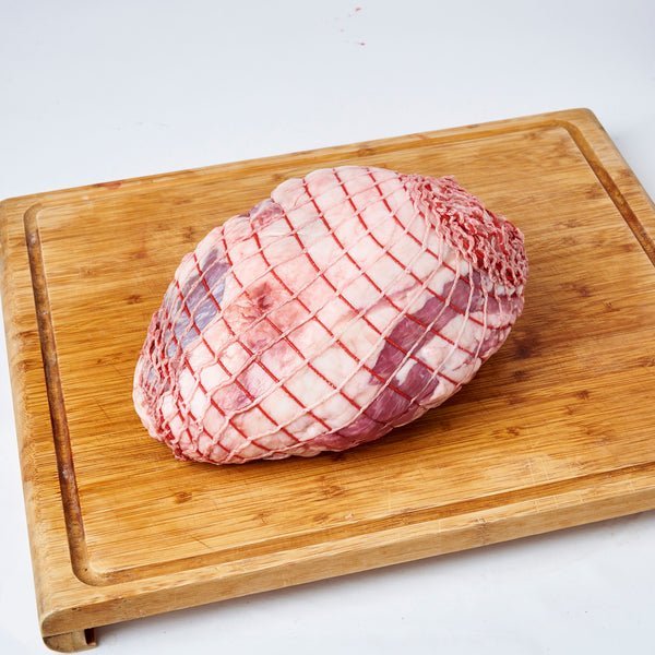 Boneless, rolled, and netted pasture-fed lamb leg, ready for roasting.